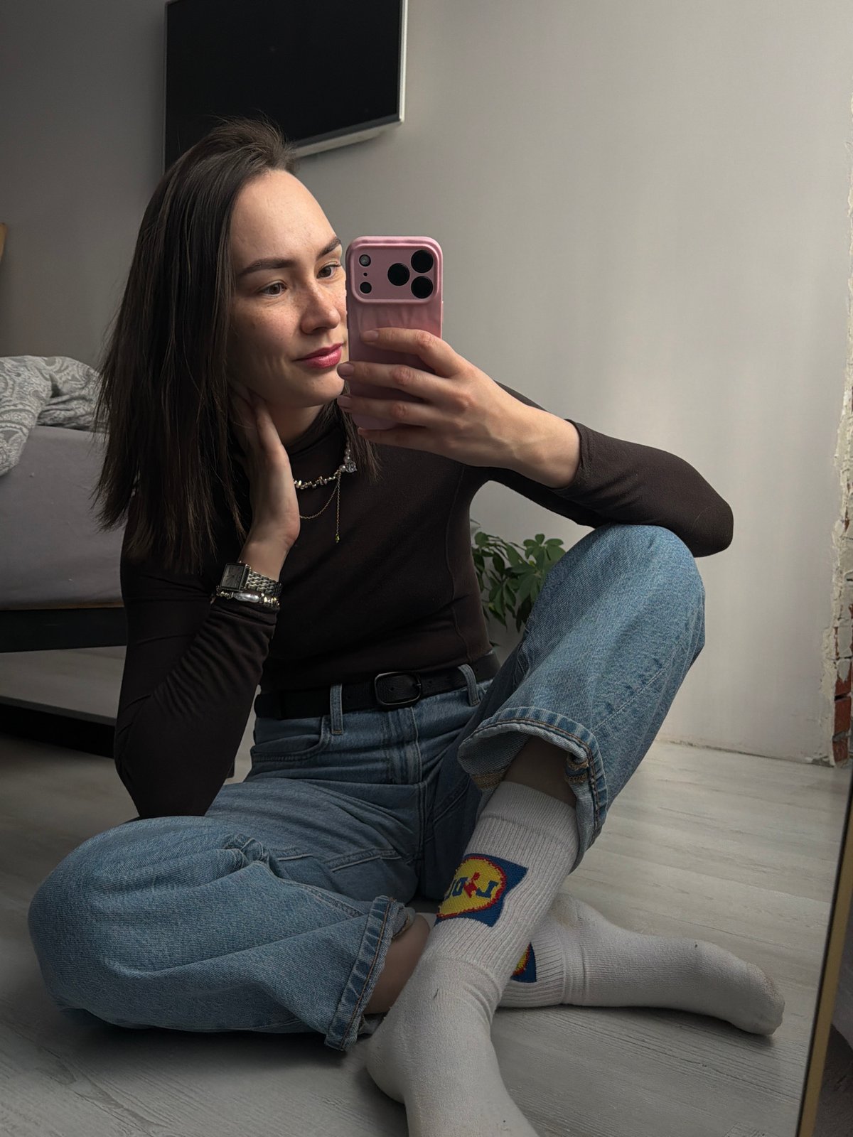 Woman takes mirror selfies indoors in Chaikovsky, Russia