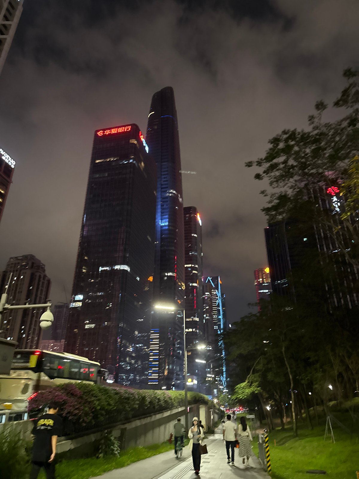 Crowds gather in Shenzhen plaza during illuminated skyscraper light show