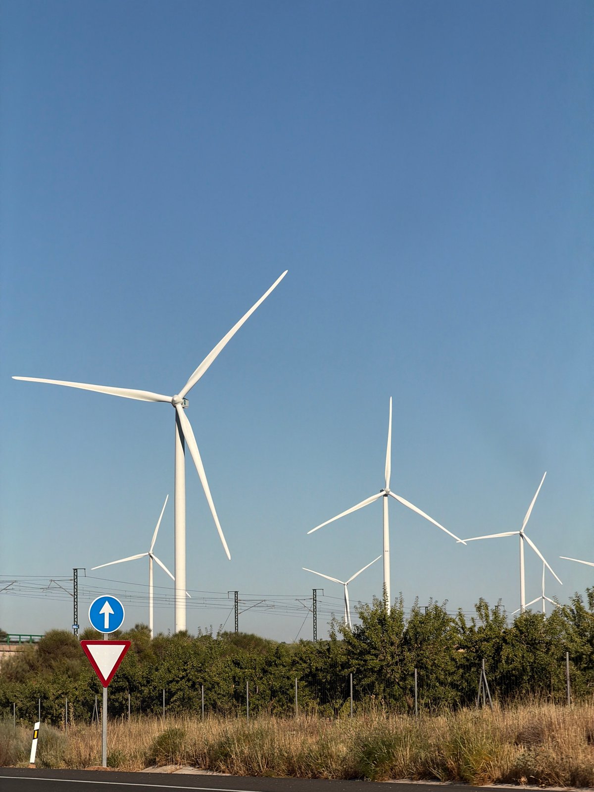 Highway scene near Motilla del Palancar with wind turbines in view