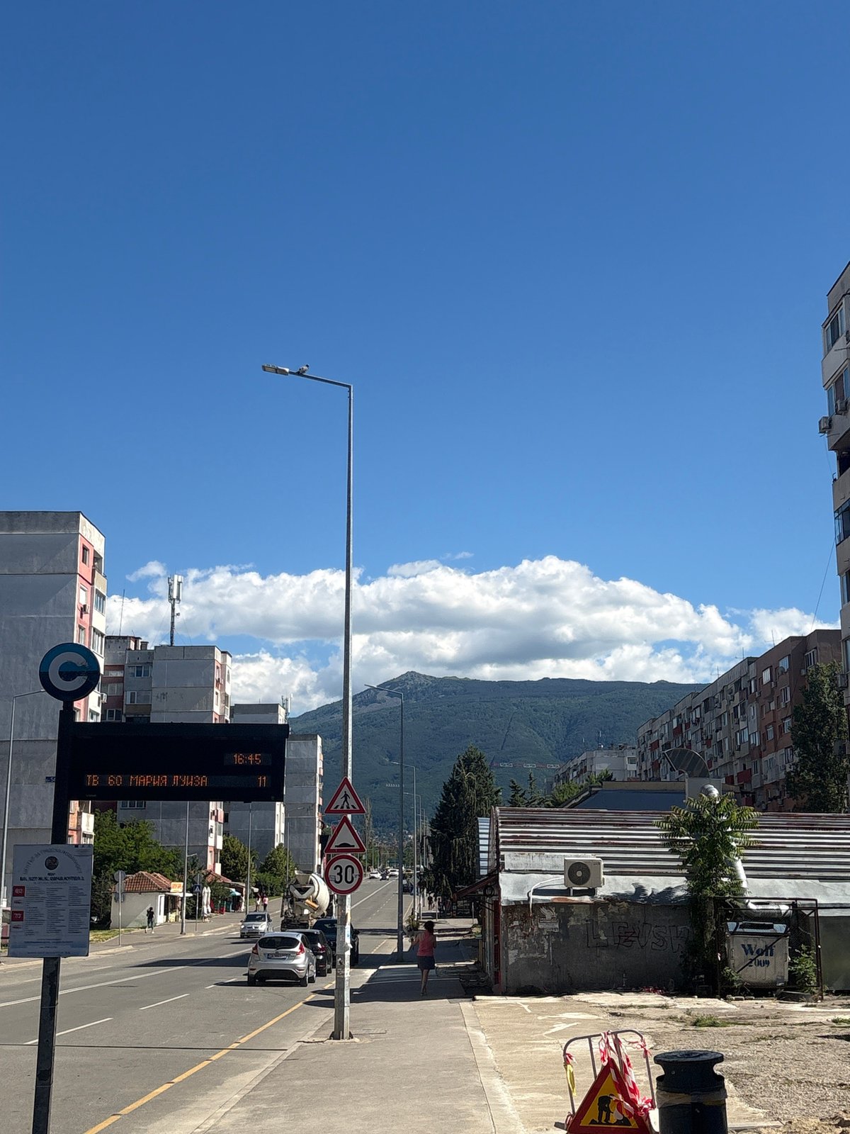 Urban neighborhood walk past construction sites and residential buildings
