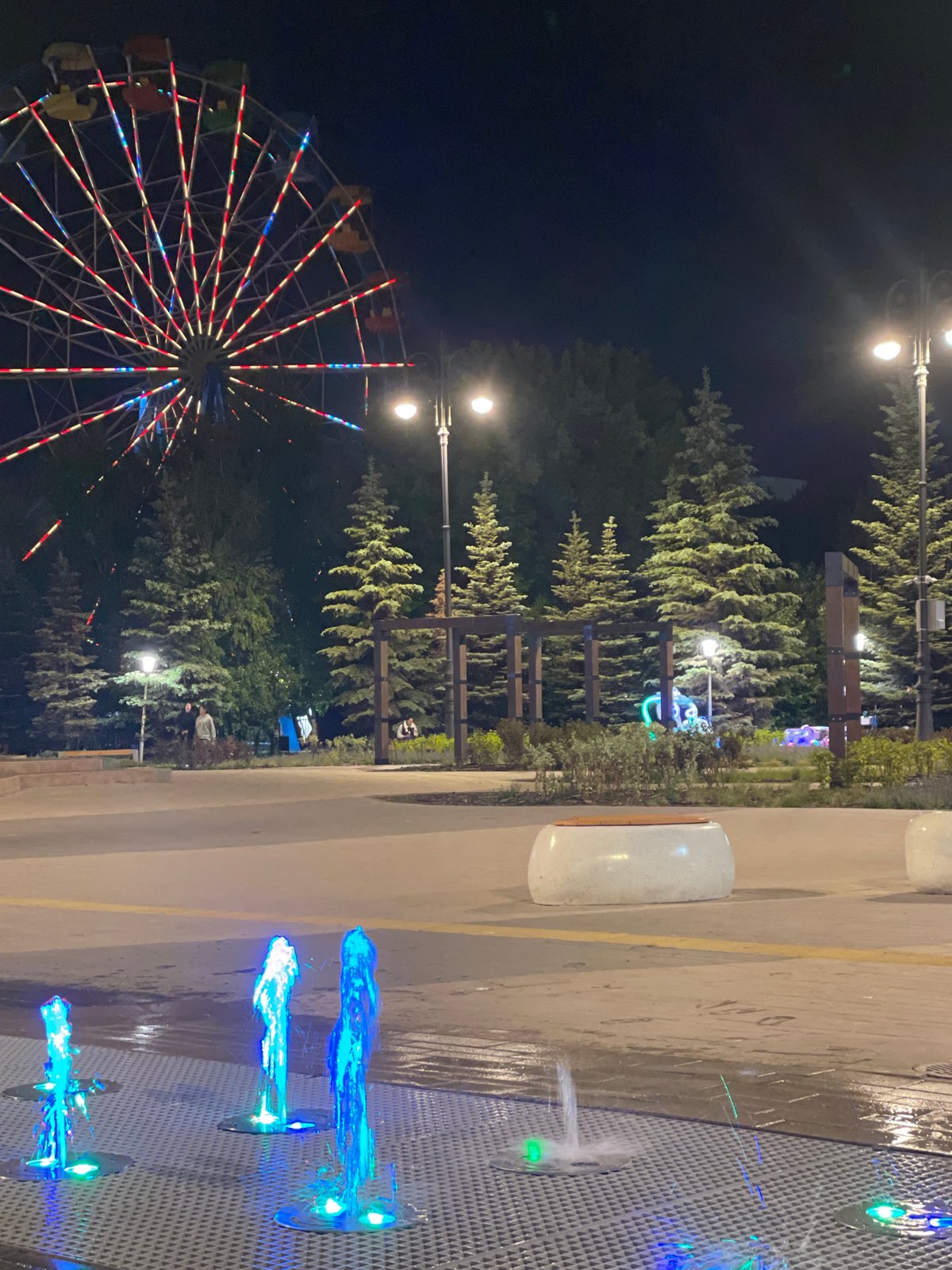 Evening cyclist captures illuminated attractions in Kokshetau, Kazakhstan