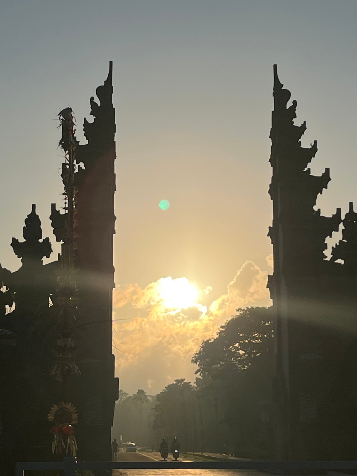 Balinese split gate silhouetted against a golden sky