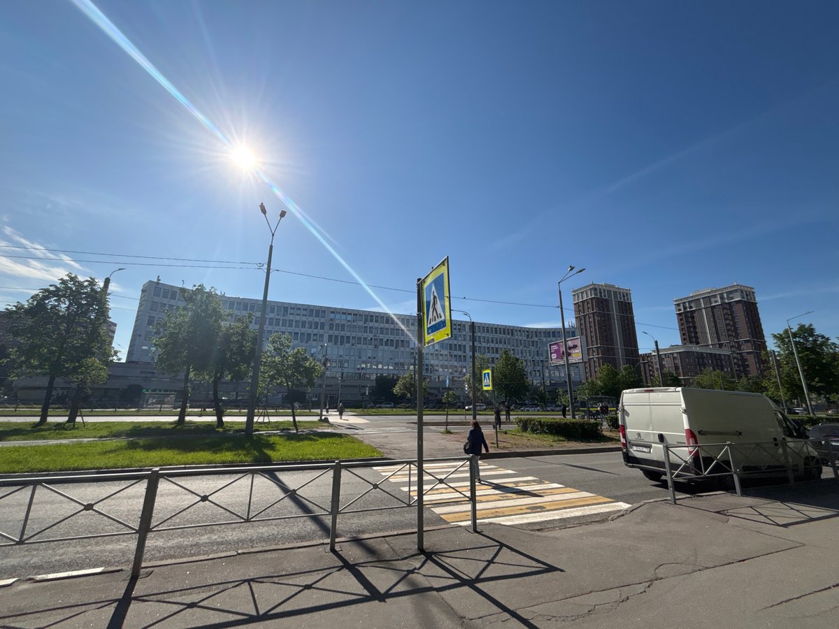 Woman documents sunny morning walk through Russian urban area
