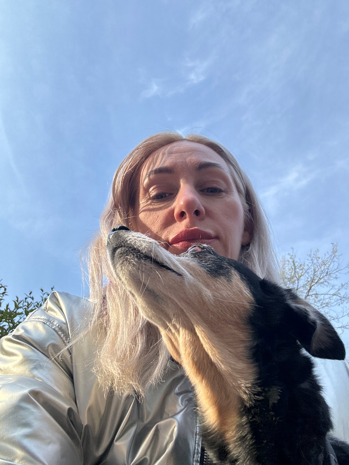 Woman photographs with dog and doll in Saint Petersburg park