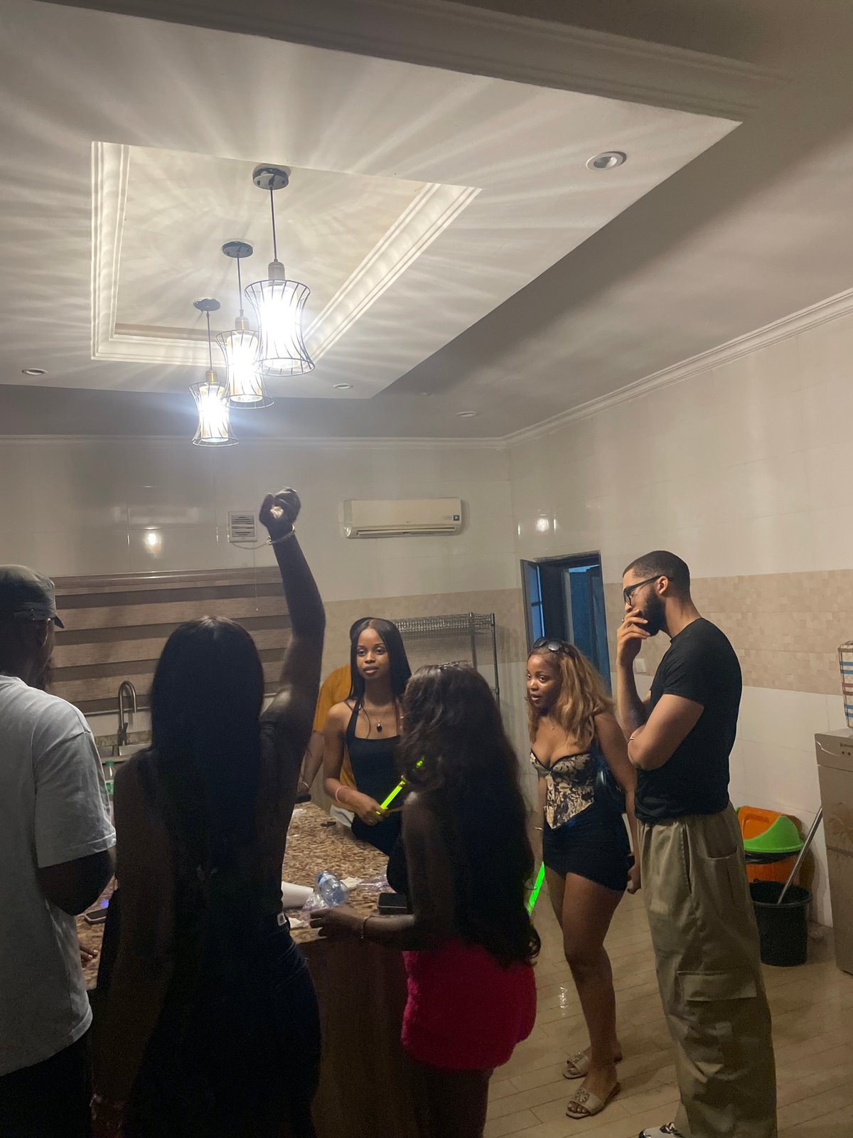 Indoor hangout in Jiru — kitchen socializing and pool table games