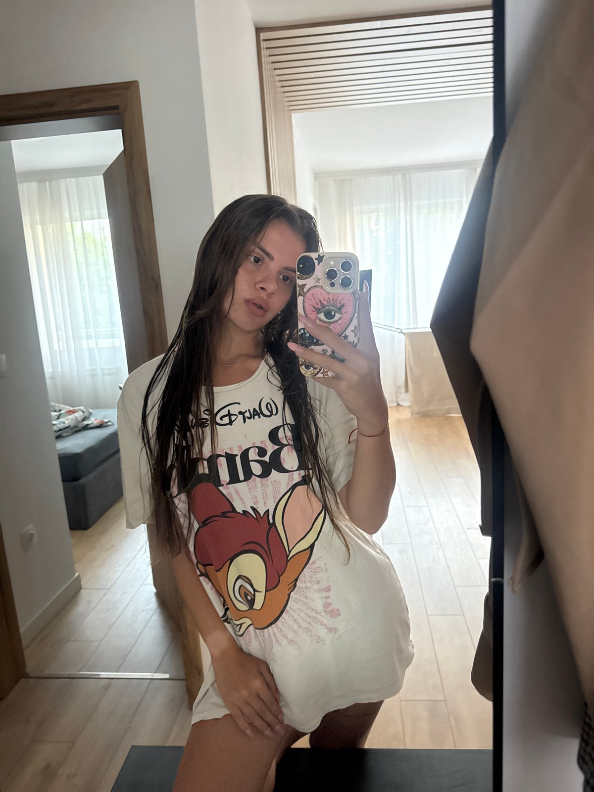 Woman documents lazy afternoon in Disney shirt, Plovdiv