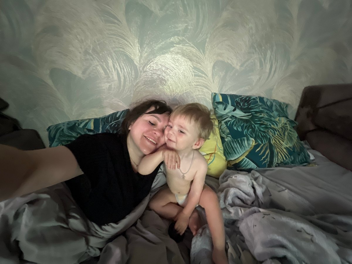 Mother and child rest in bed, Noviy Russia morning