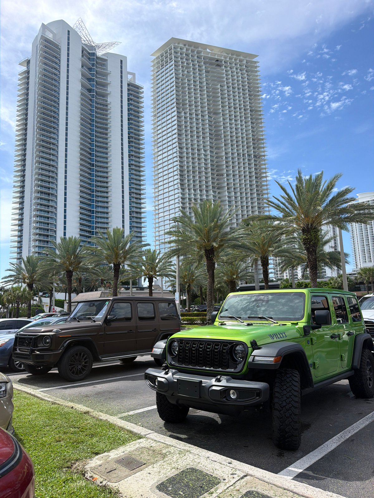 Bold green Jeep and G-Class parked in Sunny Isles Beach lot