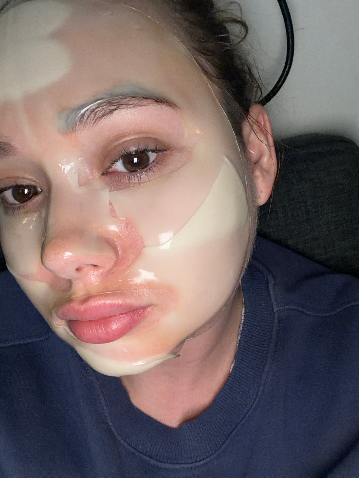 Person wearing facial sheet mask photographed in Ramat Gan