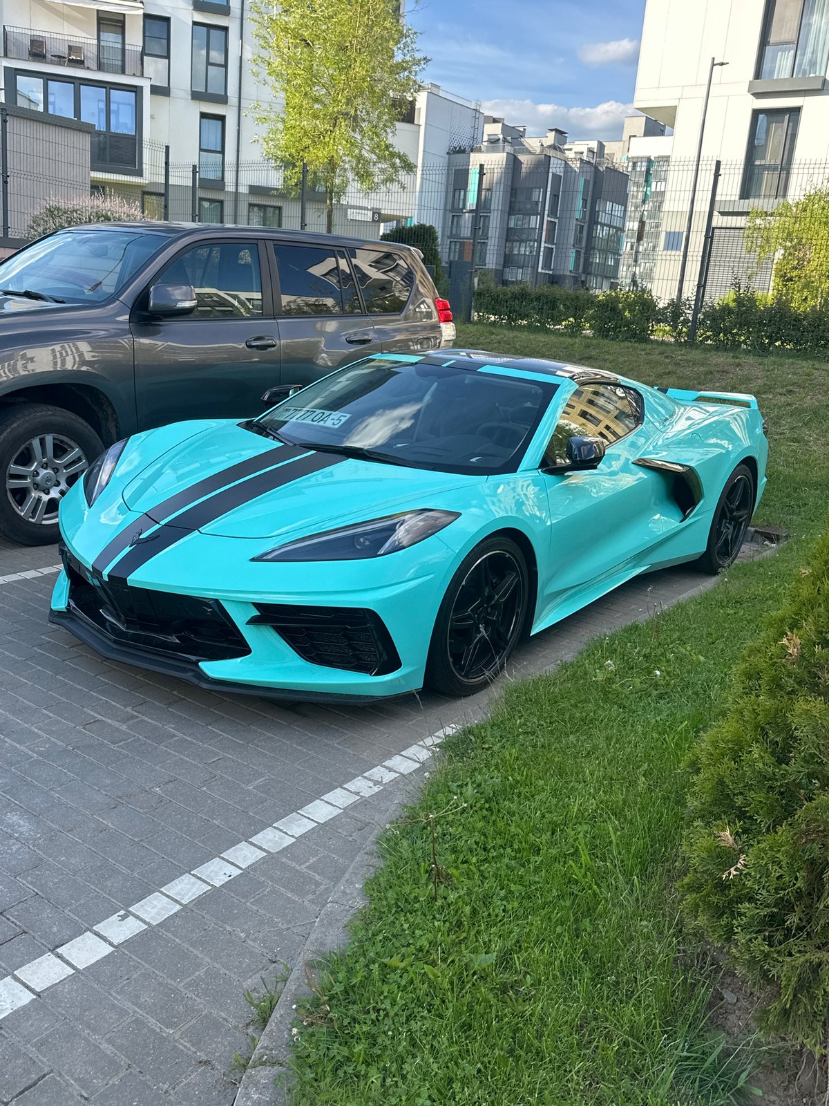 Turquoise Corvette C8 and vehicles documented in Belarus parking area