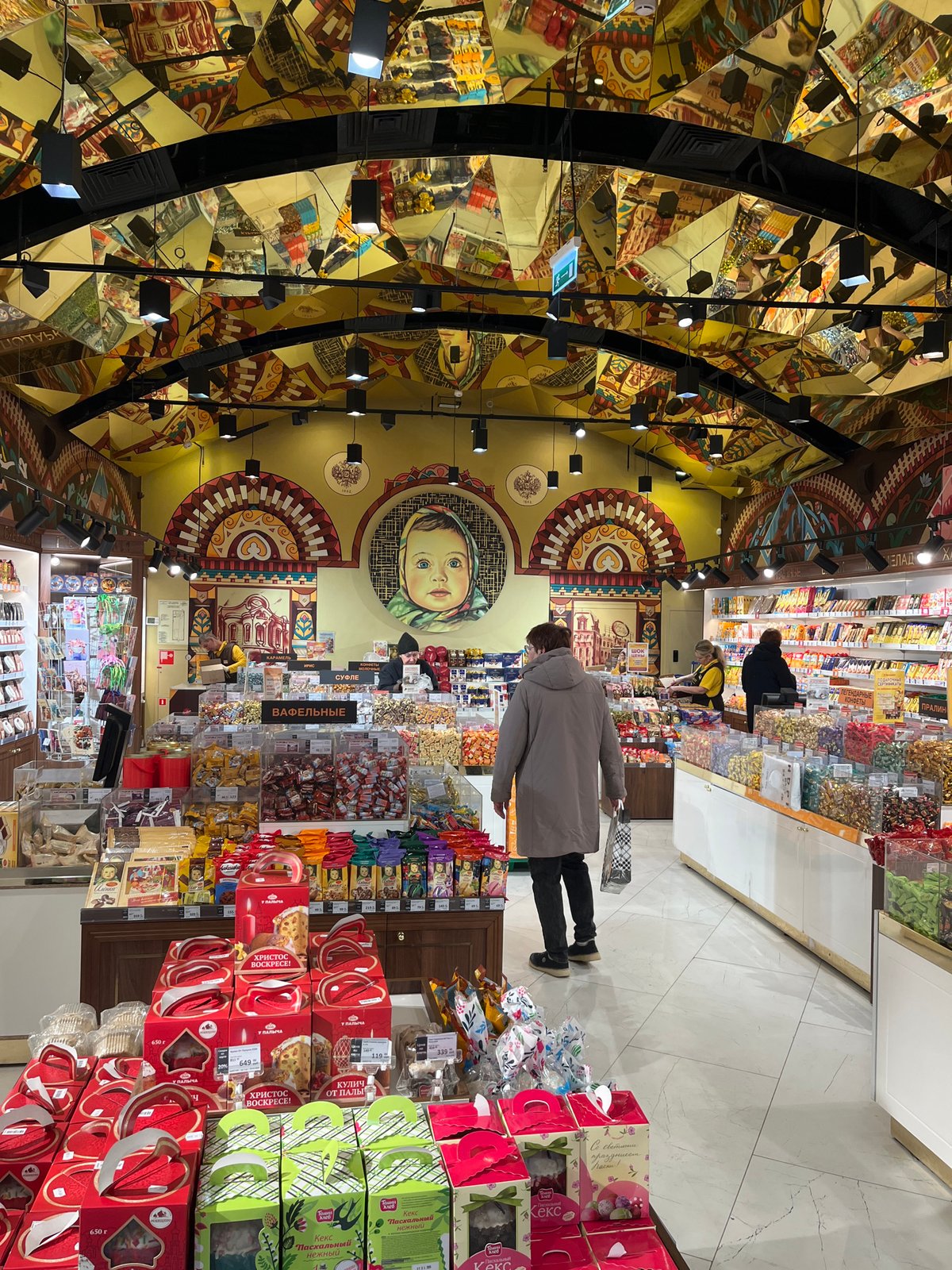 Moscow shoppers document ornate Eliseevsky store and Arbat Street scenes
