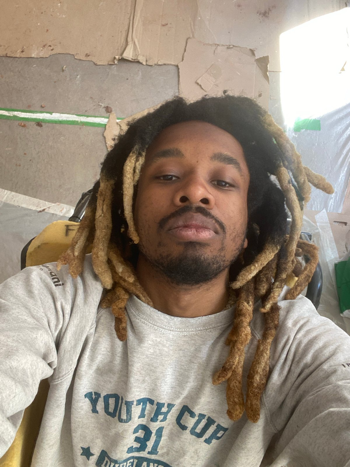 Man with distinctive dreadlocks takes selfie in Paris