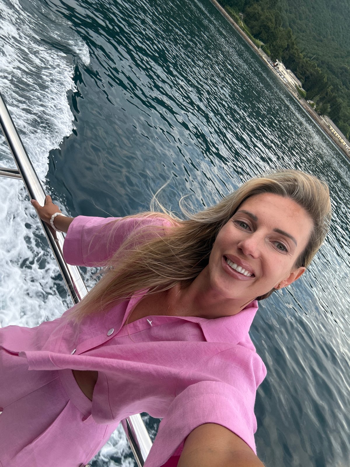Boat journey documented along Montenegro coast with selfie, wake views