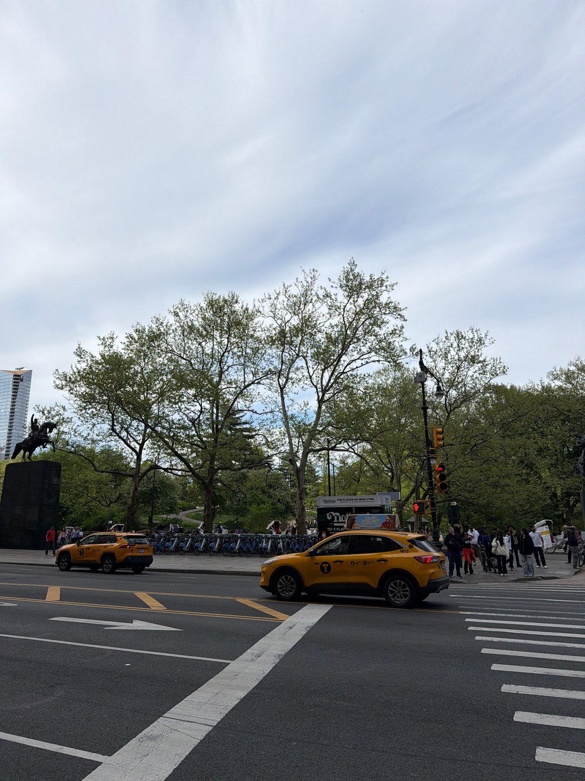Yellow taxis, pedestrians observed near Central Park crosswalk