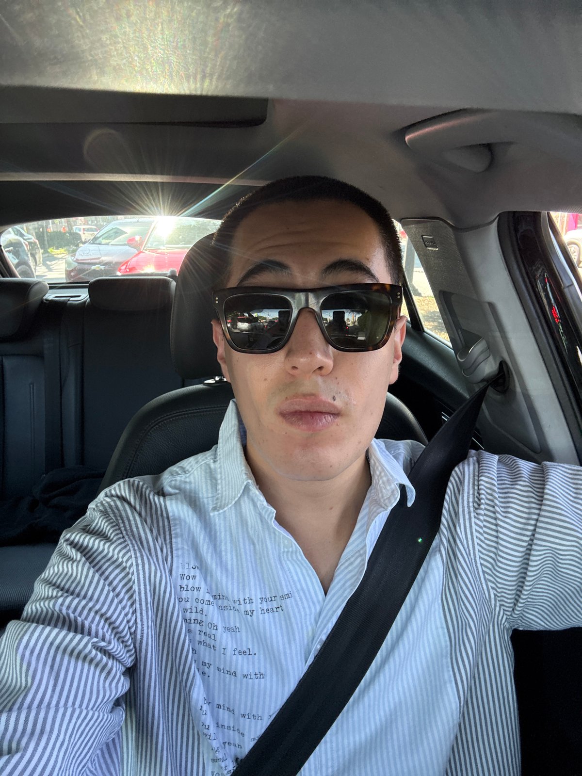 Young man takes car selfies in Puebla, Mexico