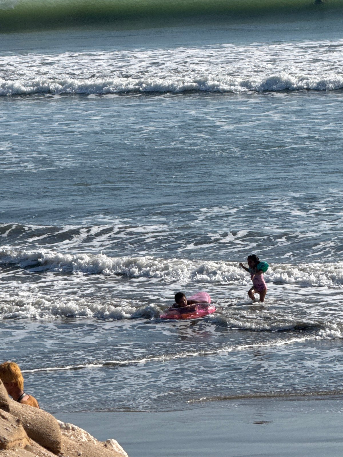 Kuta Beach morning: surf, vendors, kids, and shoreline light