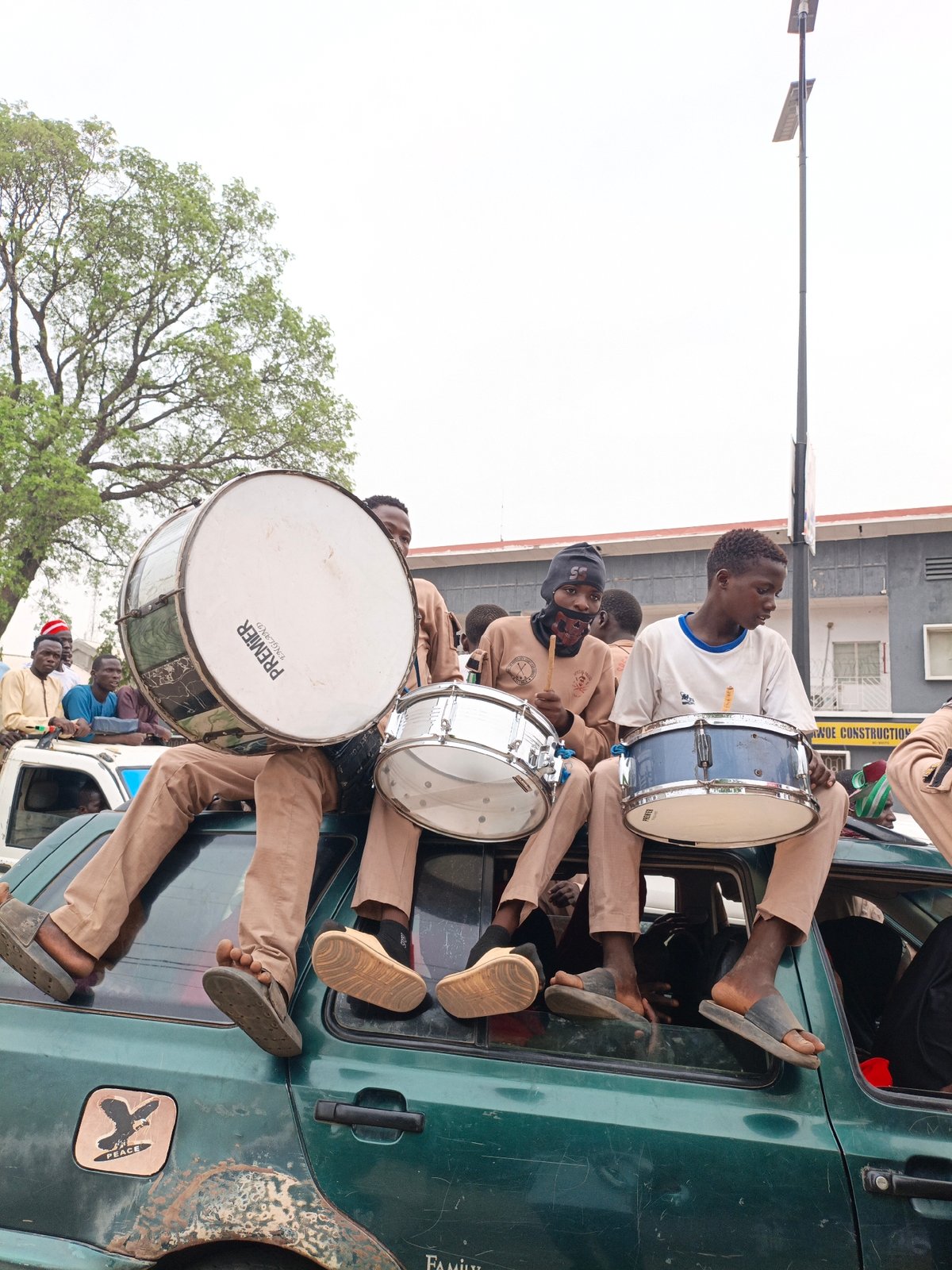 Uniformed band members and political banner spotted in urban area