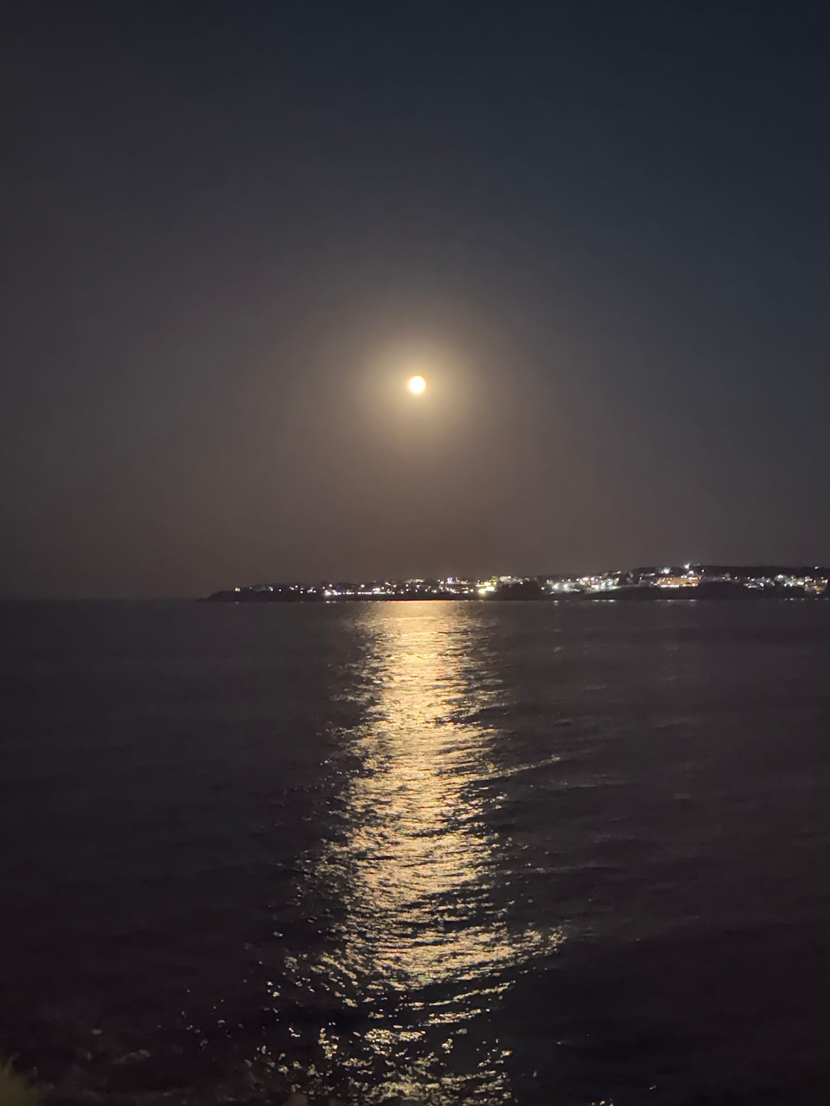 Sozopol waterfront glows under a full moon at night