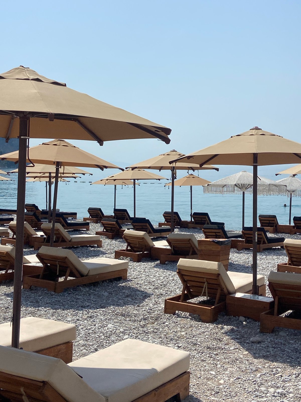 Busy pebble beach morning on the Montenegrin coast