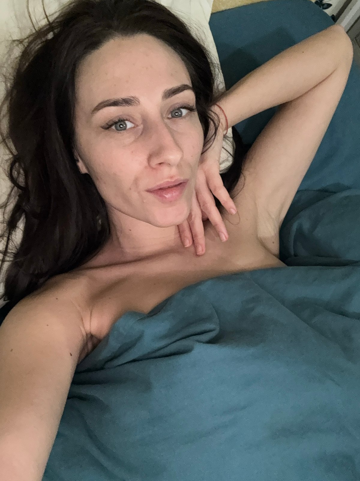 Woman rests on bed in Saint Petersburg apartment