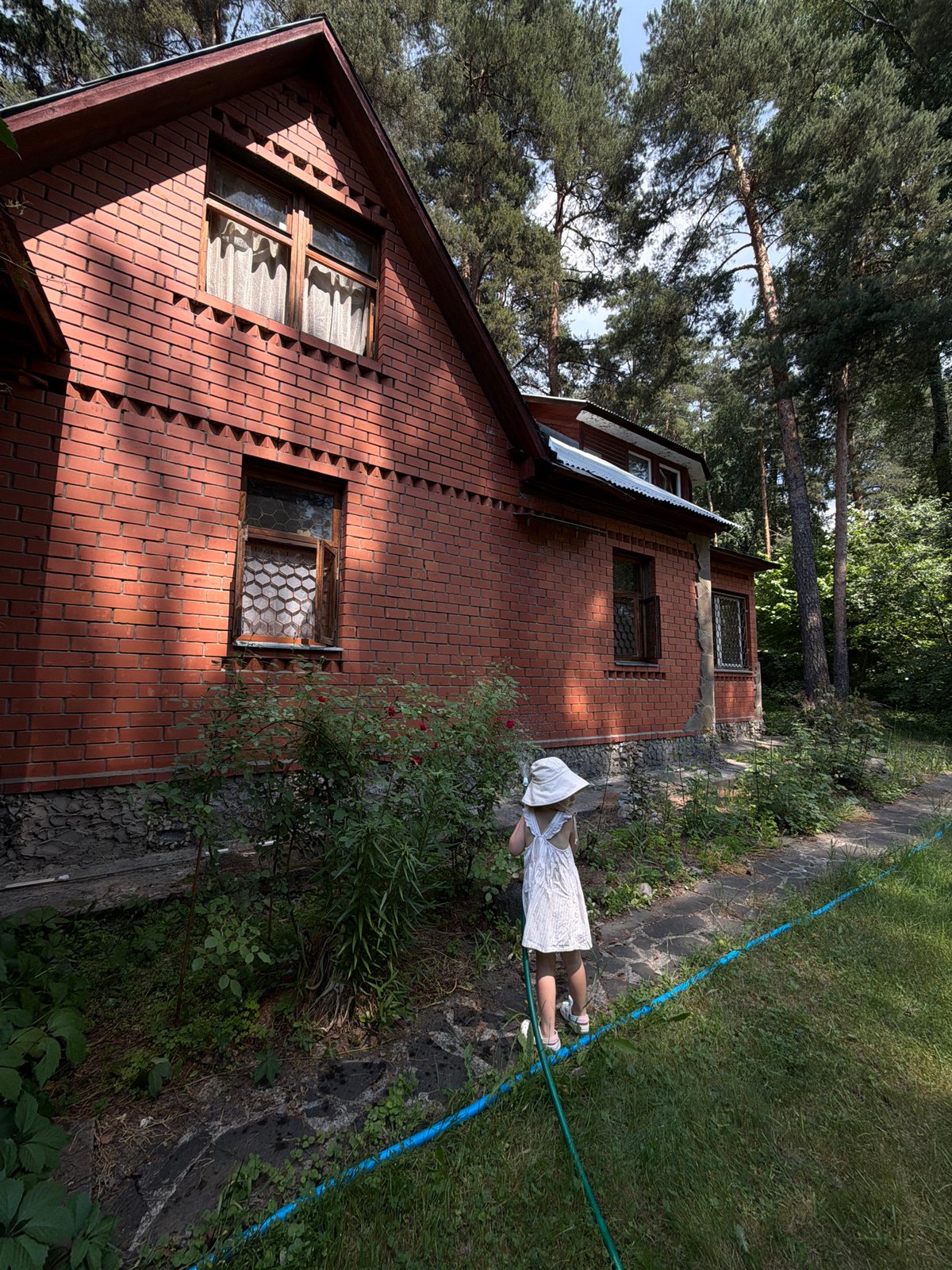 Child plays in backyard in Udelnaya, Russia