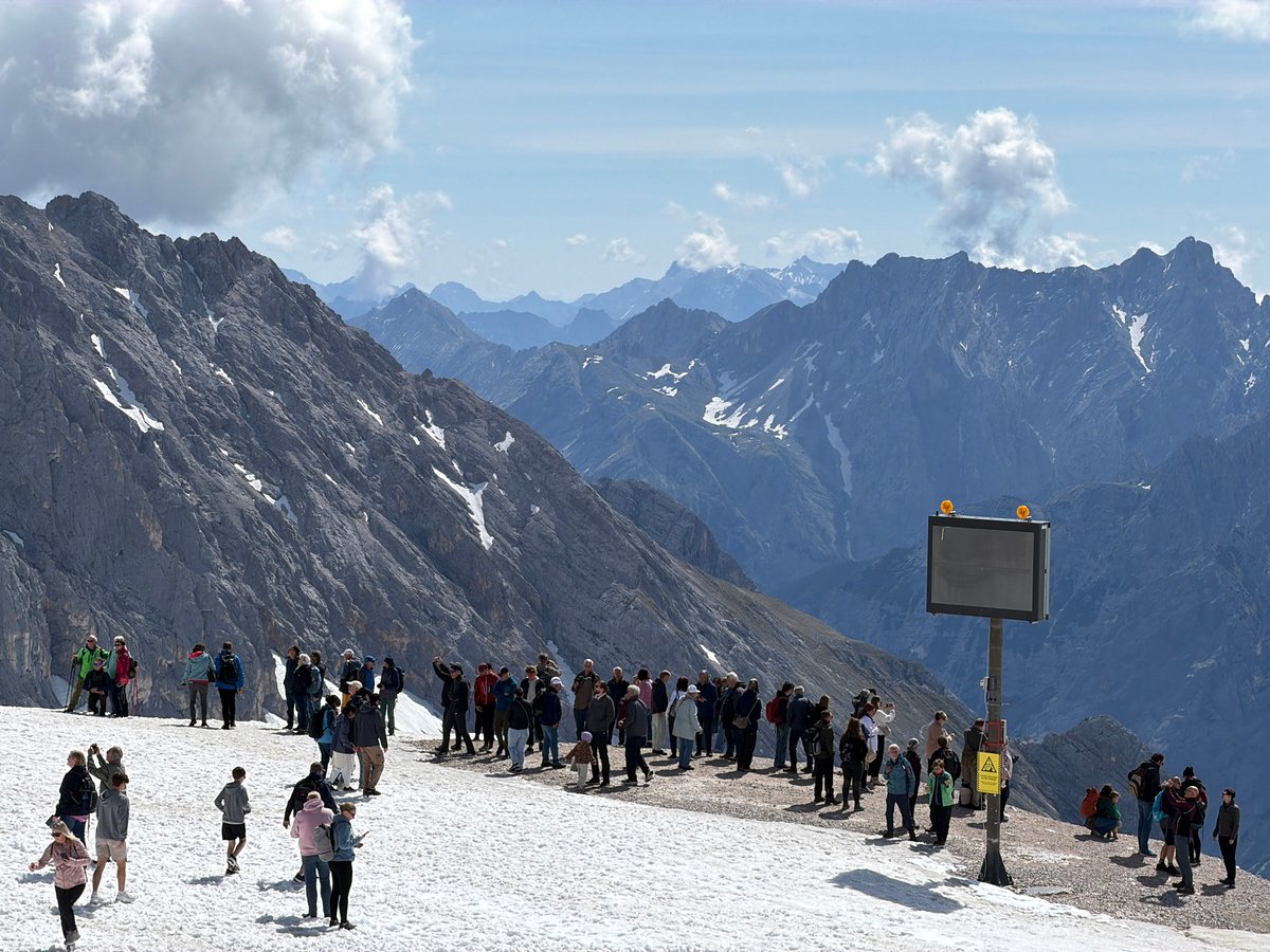 Tourists visit snow-covered Zugspitze peak in Bavarian Alps