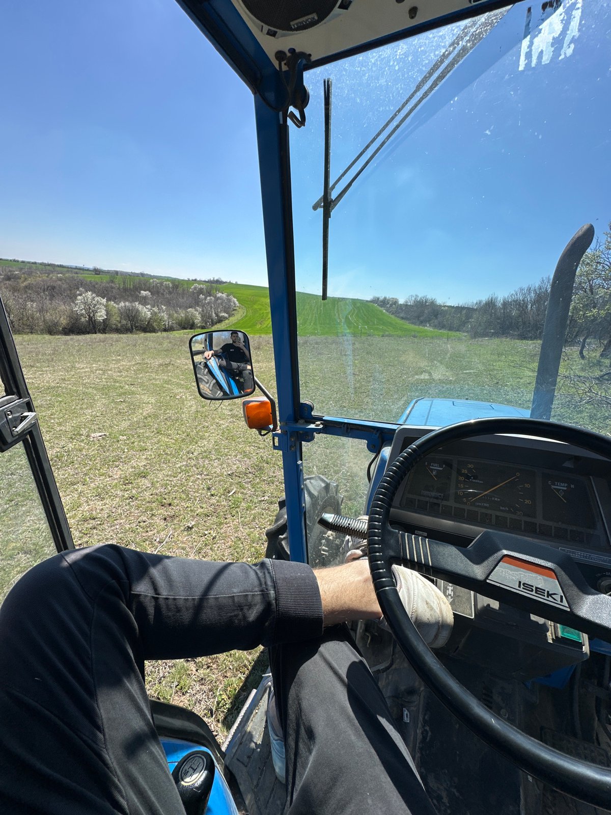 Tractor operator documents rural view in Bulgarian countryside