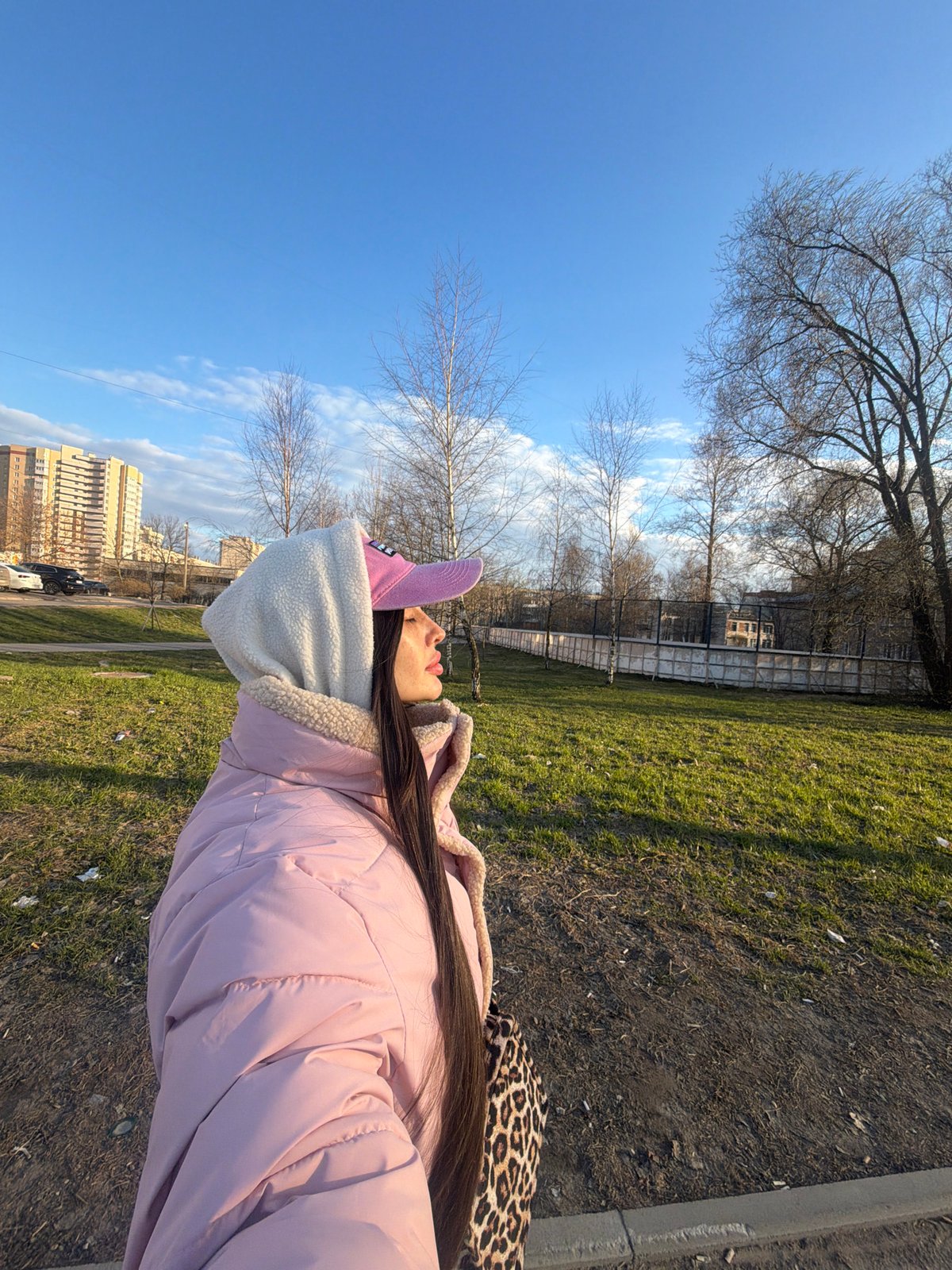 Woman in pink cap documented across Saint Petersburg locations