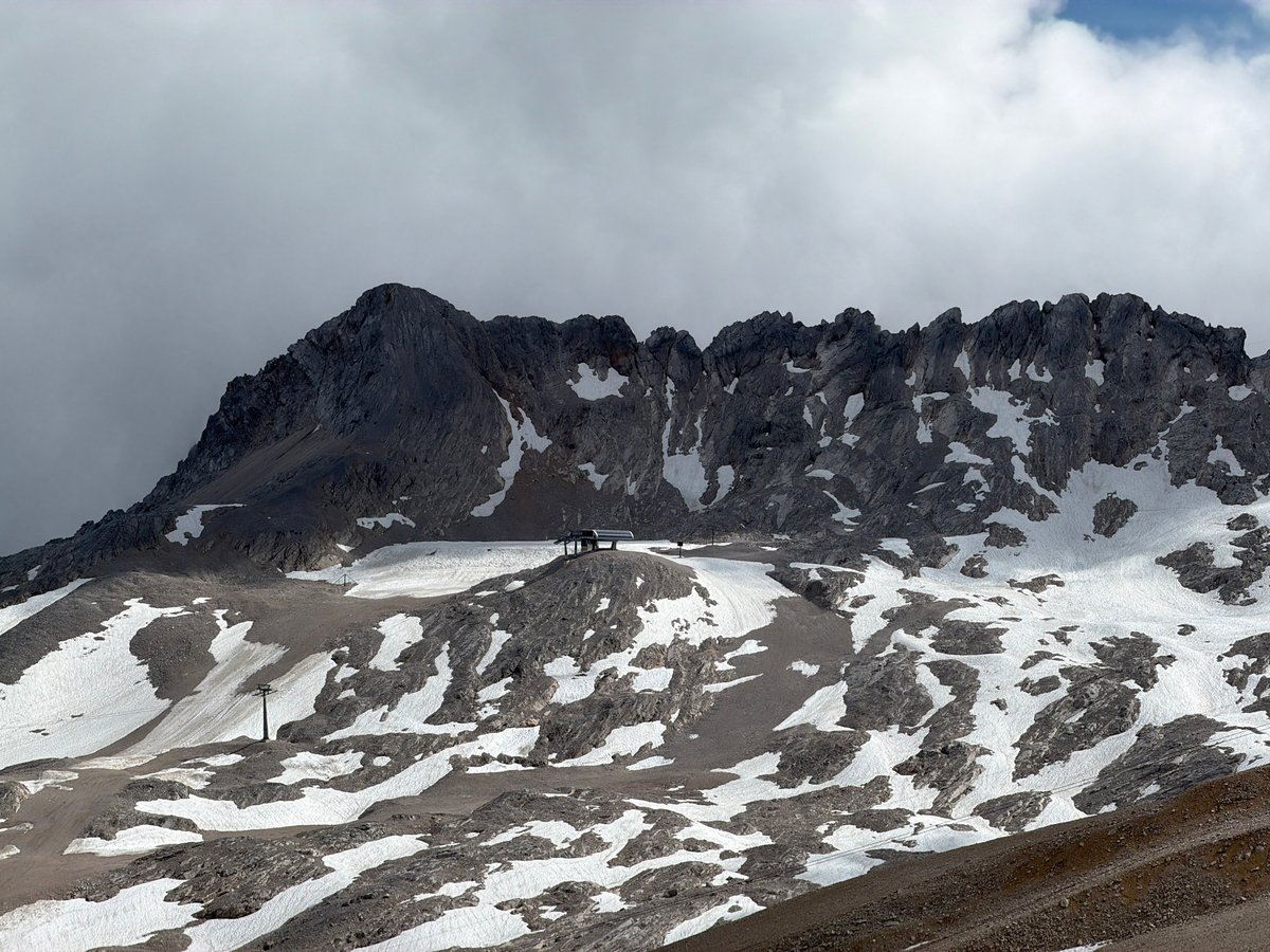 Snow, stone chapel, and cable car at Germany's highest peak