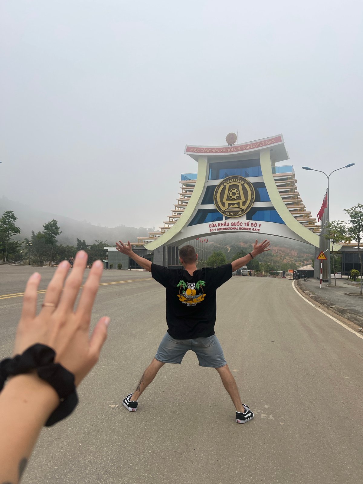Tourist poses playfully at Vietnam's Bờ Y International Border Gate