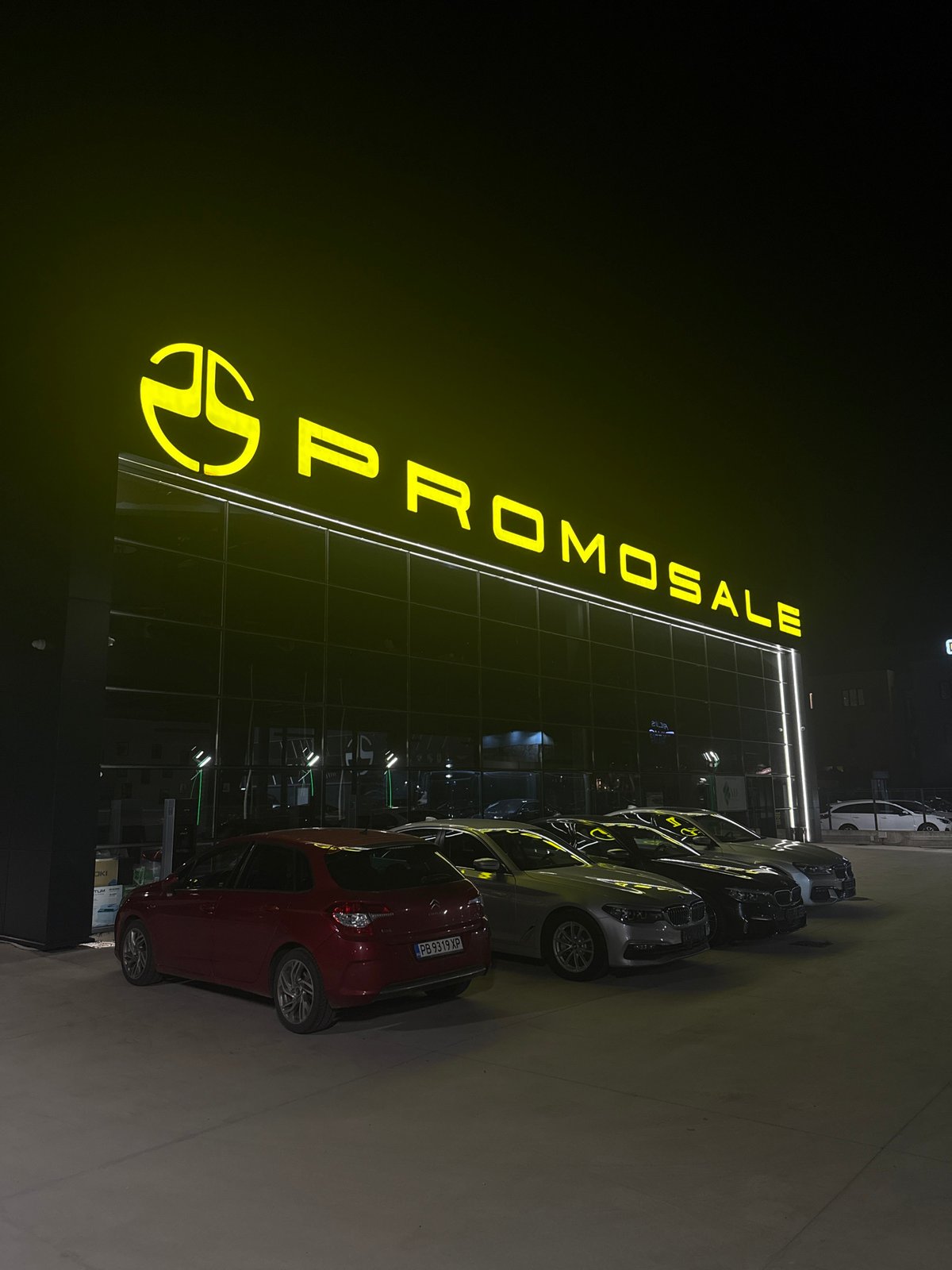 Car dealership operates under night lights in Plovdiv