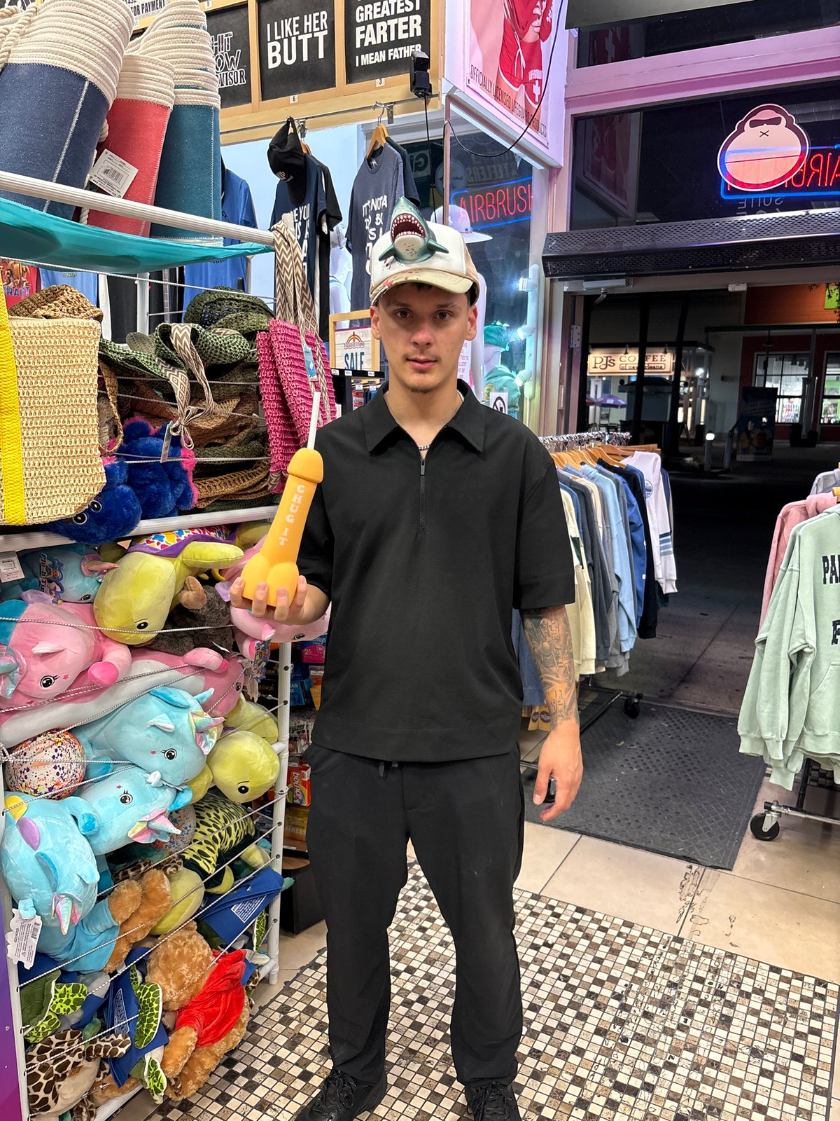 Man holds novelty toy outside Panama City Beach store