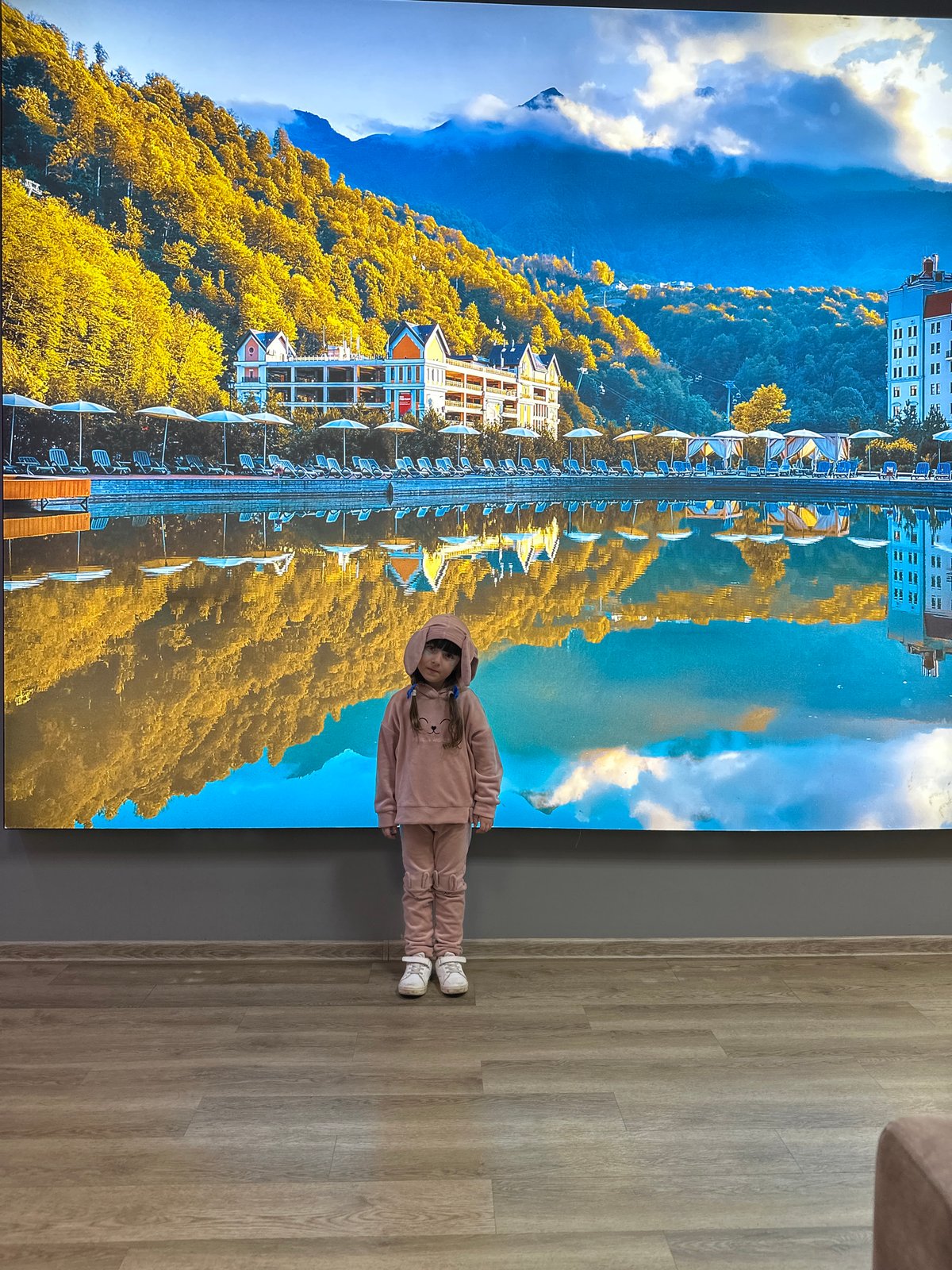 Girl in pink spotted at screen display, grocery store in Sochi