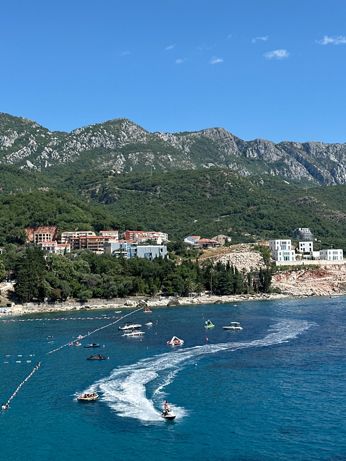 Sunny afternoon on the Montenegrin coast, jet skis and calm bays