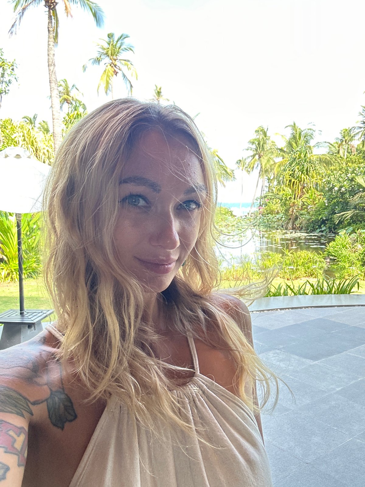 Two women take selfies at Vietnamese outdoor restaurant