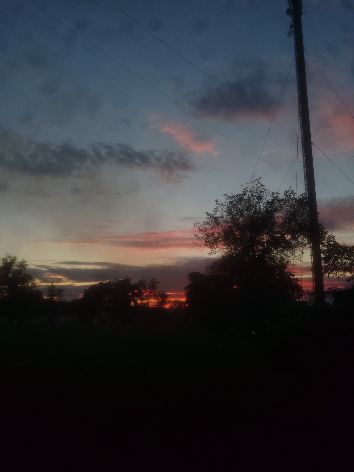 Outdoor evening hangout, drinks in hand, sunset backdrop