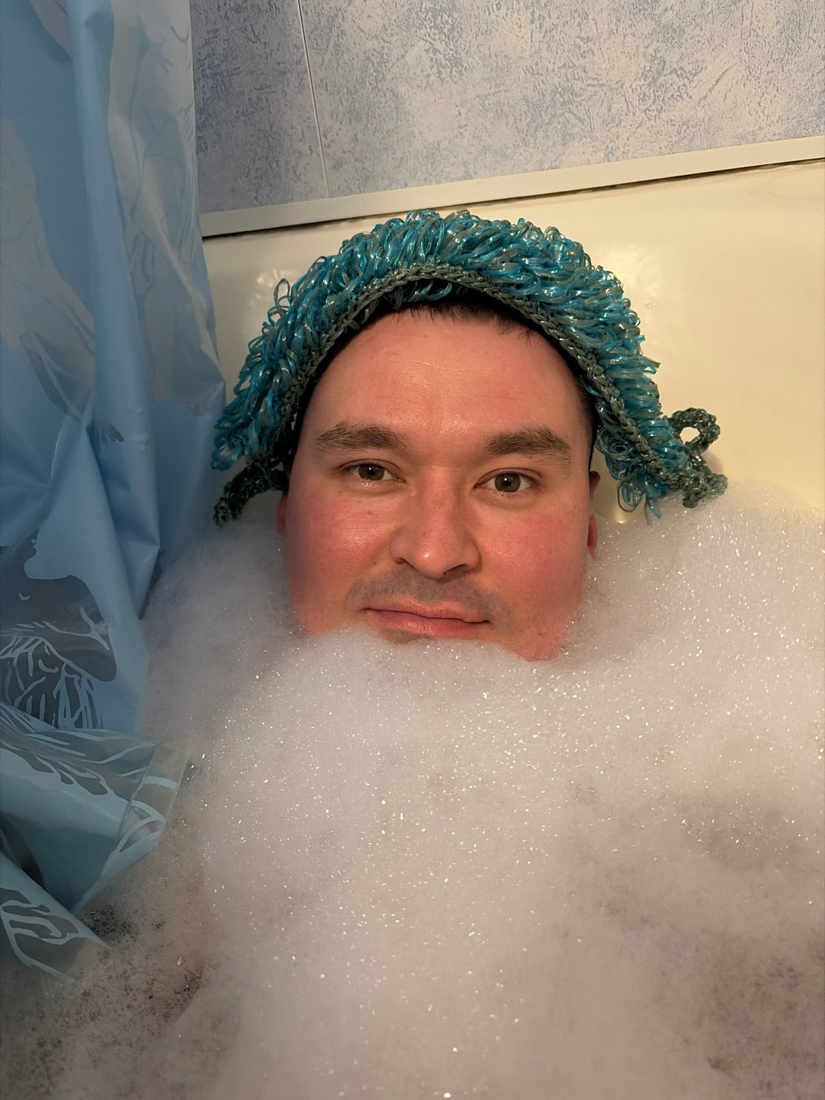 Man Takes Playful Bubble Bath Wearing Swimming Goggles in Izhevsk