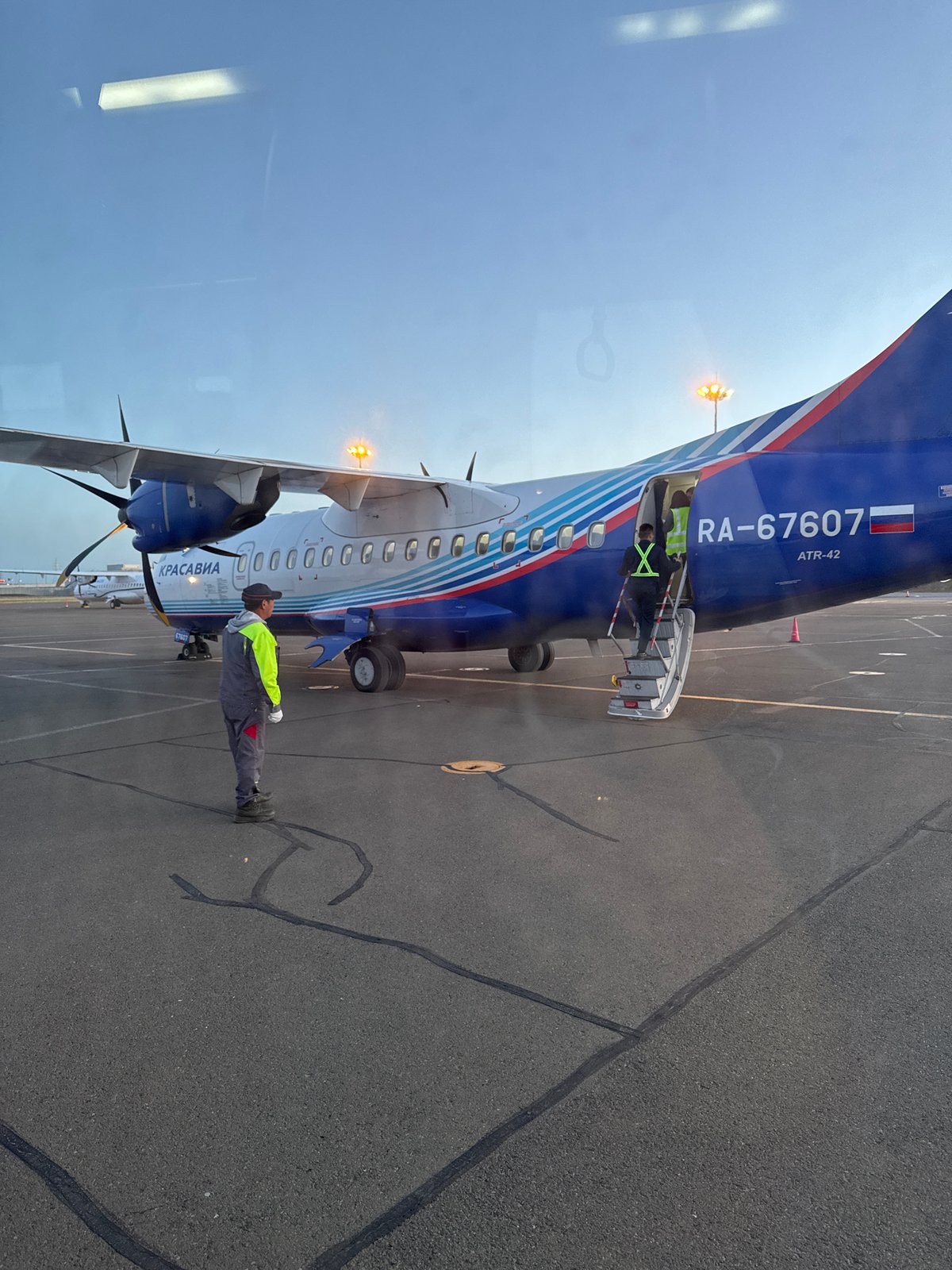ATR-42 aircraft serviced by ground crew in Zuunmod, Mongolia