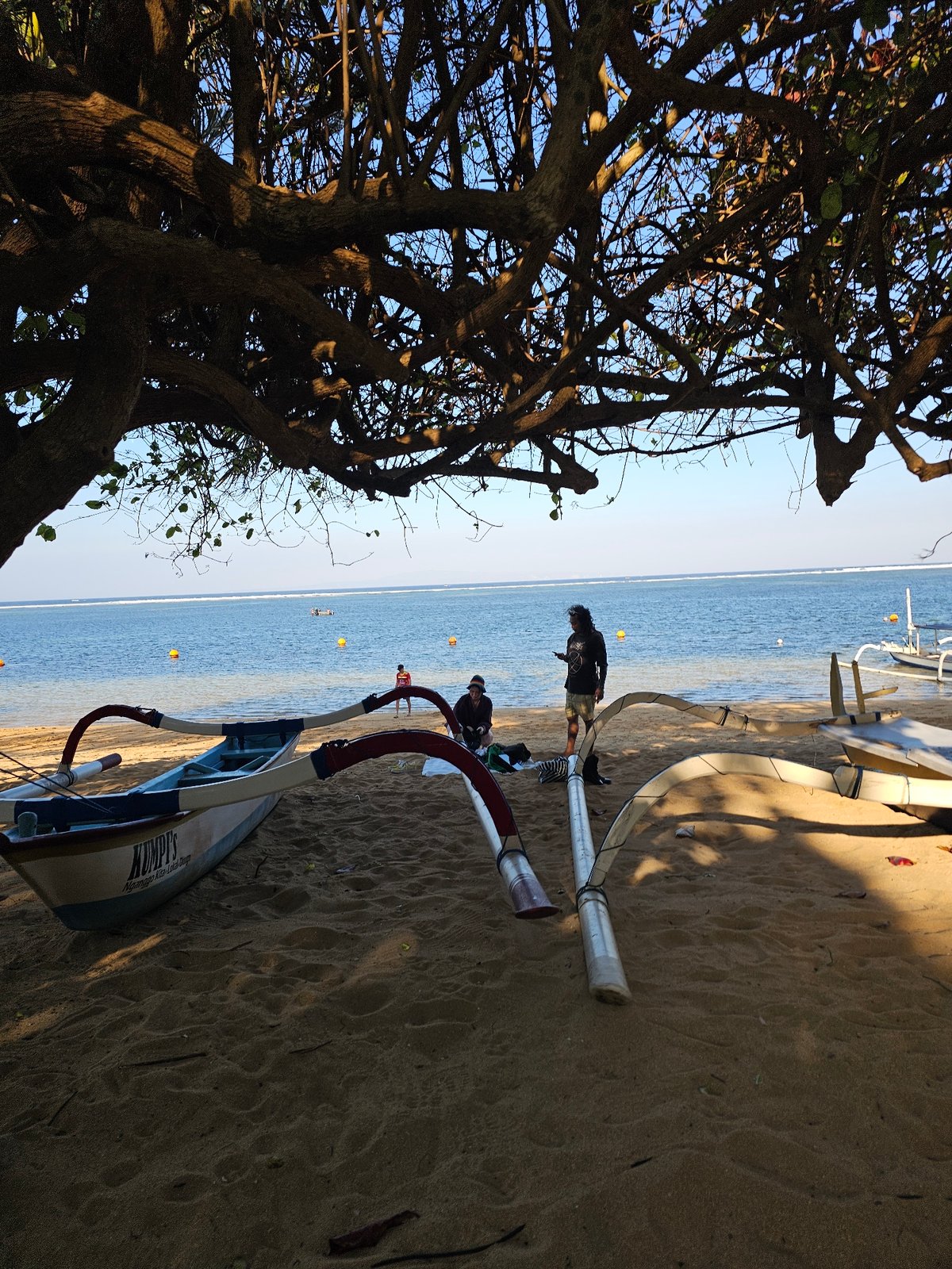 Sanur Beach morning: promenade walks, beachside barbecue, open-air dining setup