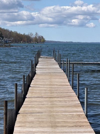 Weathered wooden pier documented on Moravia lake under cloudy skies