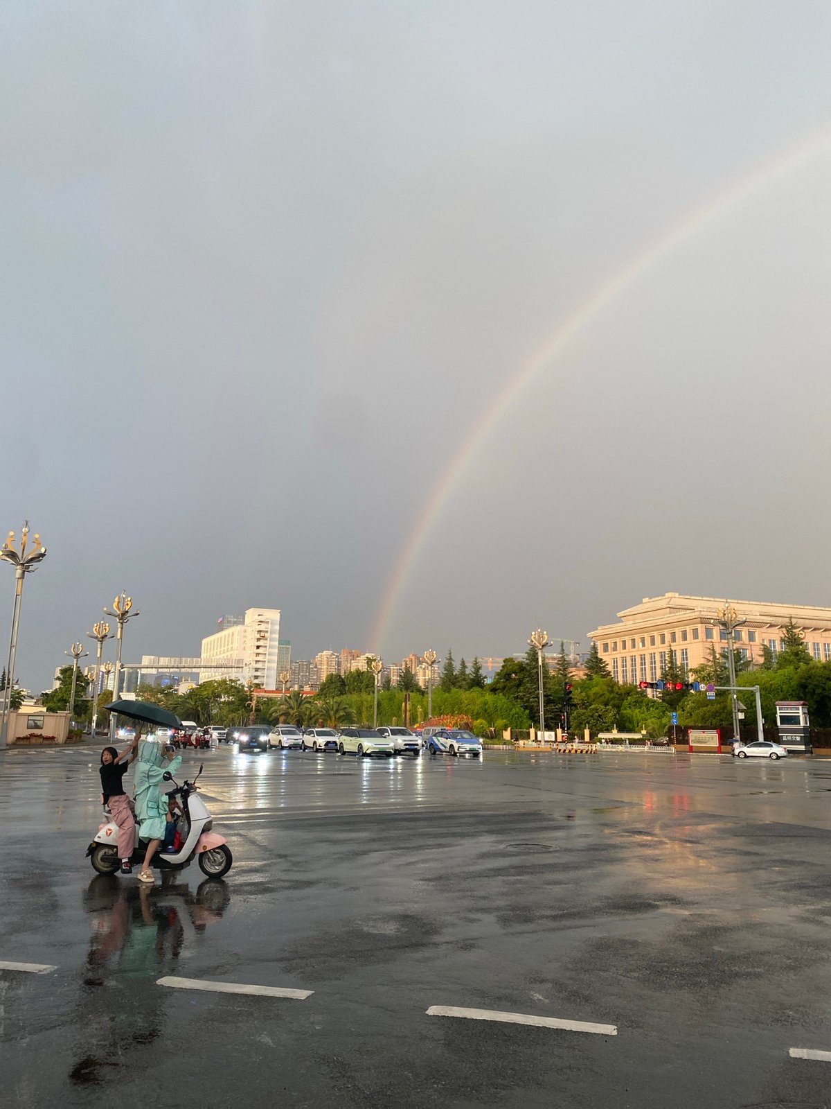 Rainbow over wet streets in Xishan District after summer rain