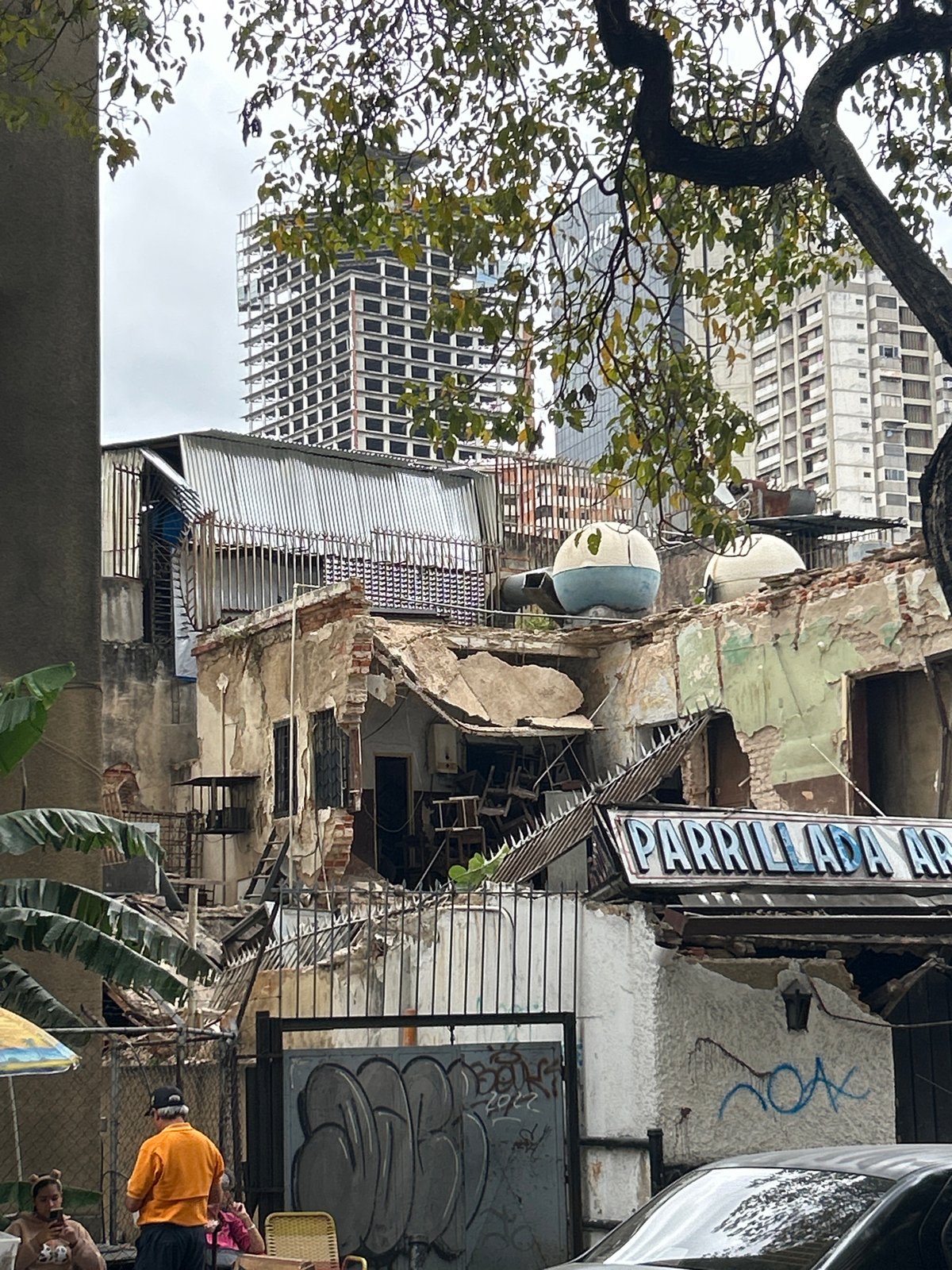 Crumbling apartment facades amid Caracas high-rises