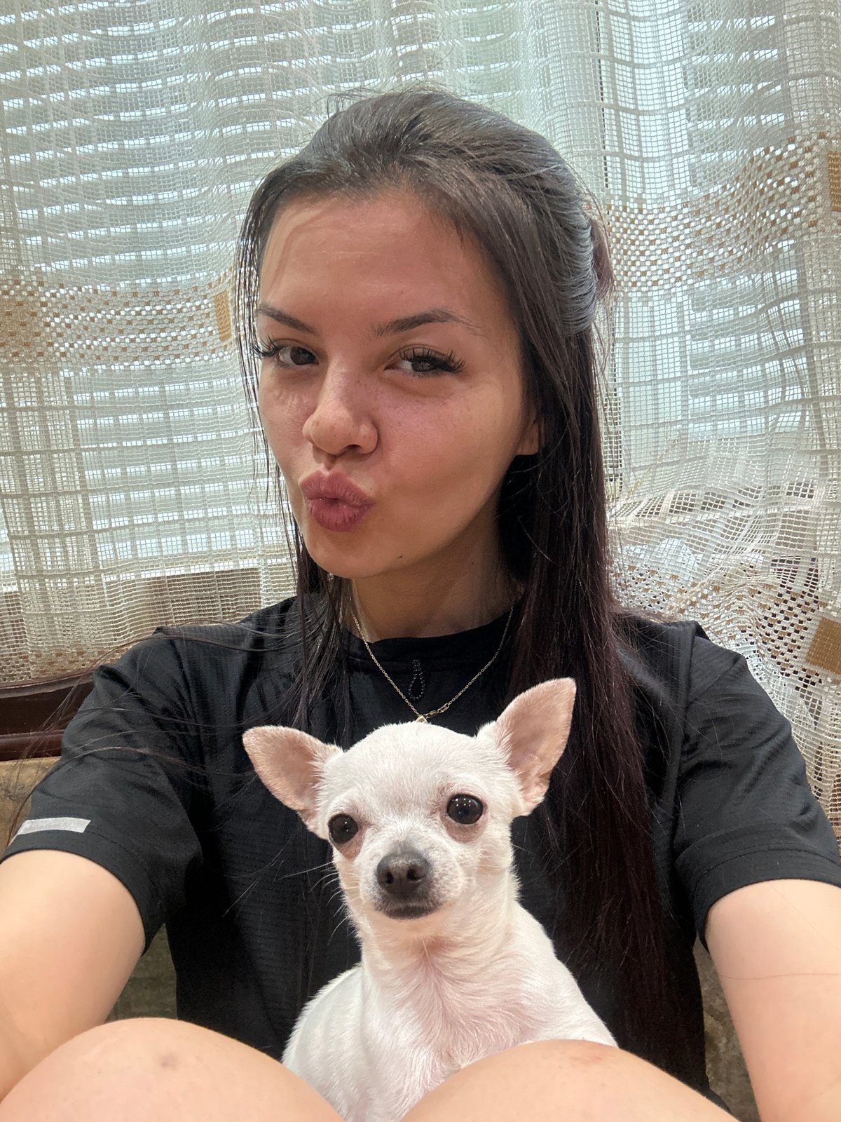 Woman takes playful selfies with white Chihuahua in Bulgaria