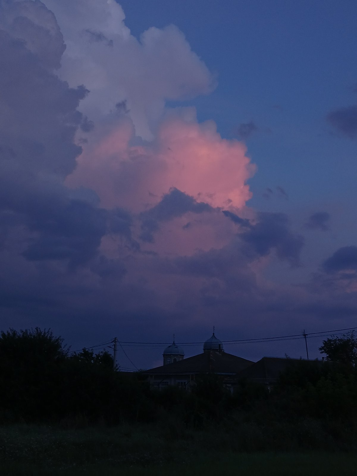 Storm clouds and a watchful German Shepherd in rural Moldova