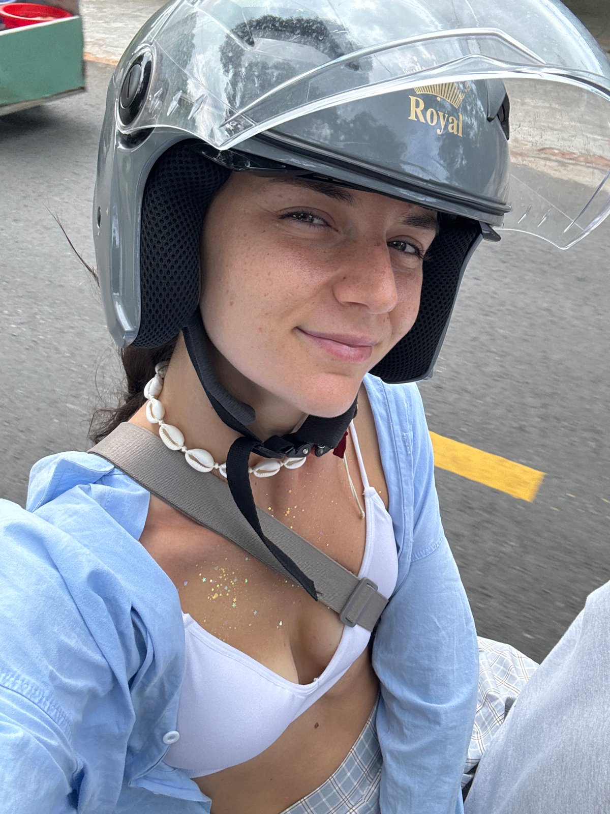 Woman rides motorcycle in bikini through Mũi Né streets