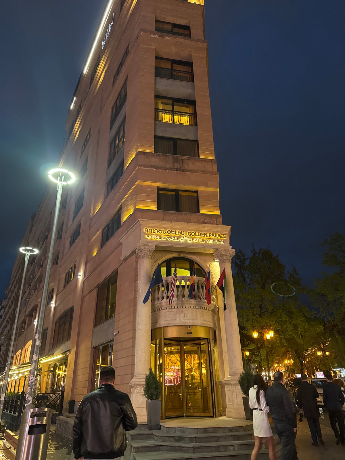 Illuminated hotel captures attention on wet Yerevan street