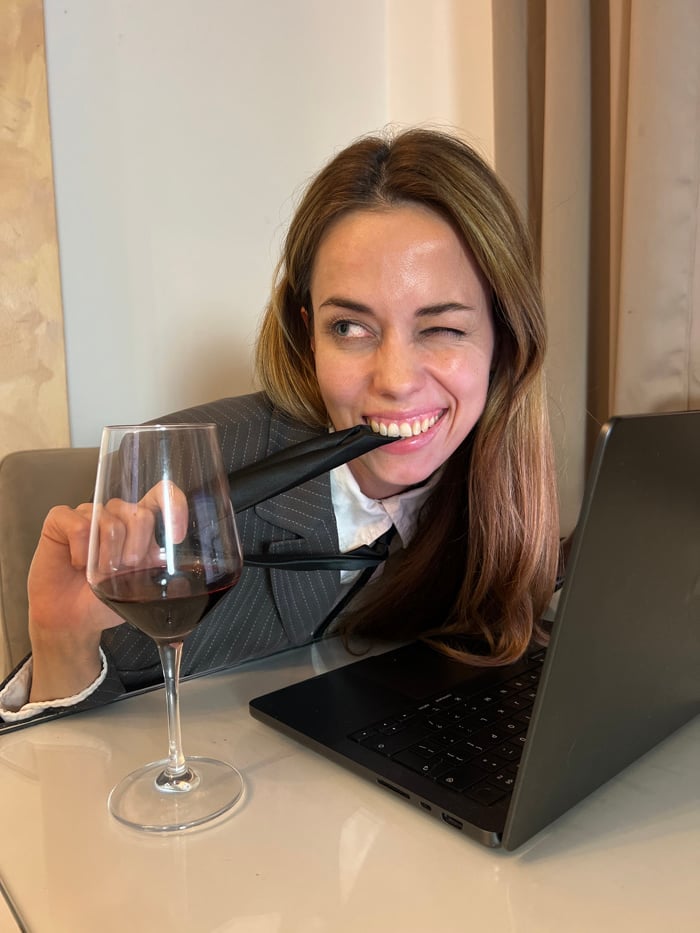 Woman works, poses with wine at Montenegro location