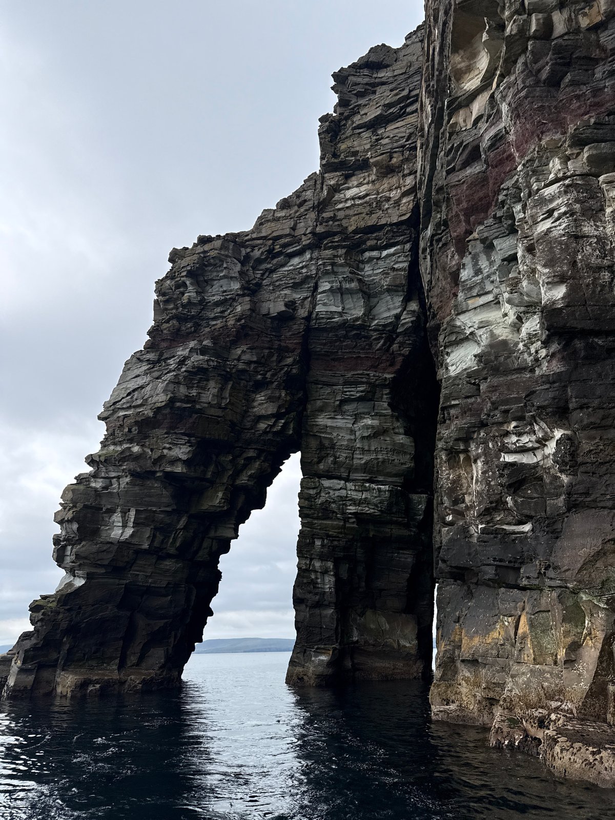 Shetland sea stacks, arches, and stratified cliffs up close