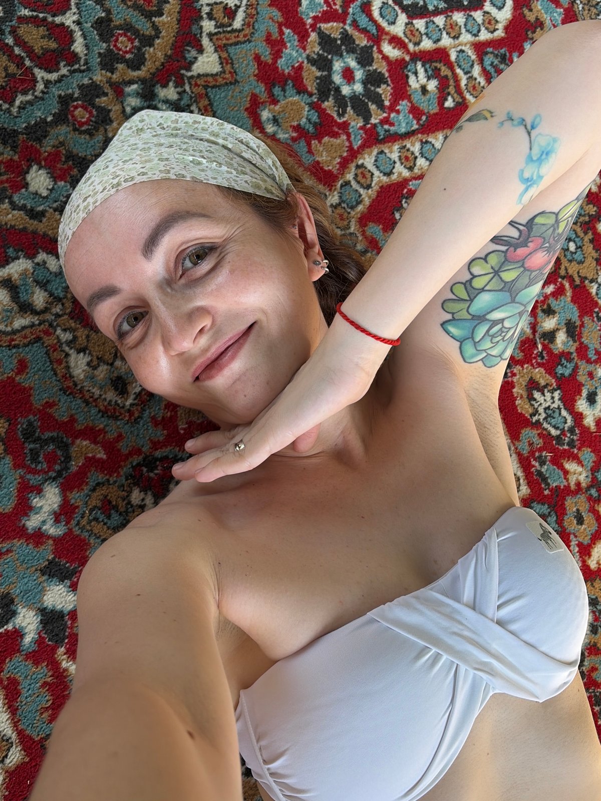 Woman photographed with ornate rug in Chaikovsky, Russia
