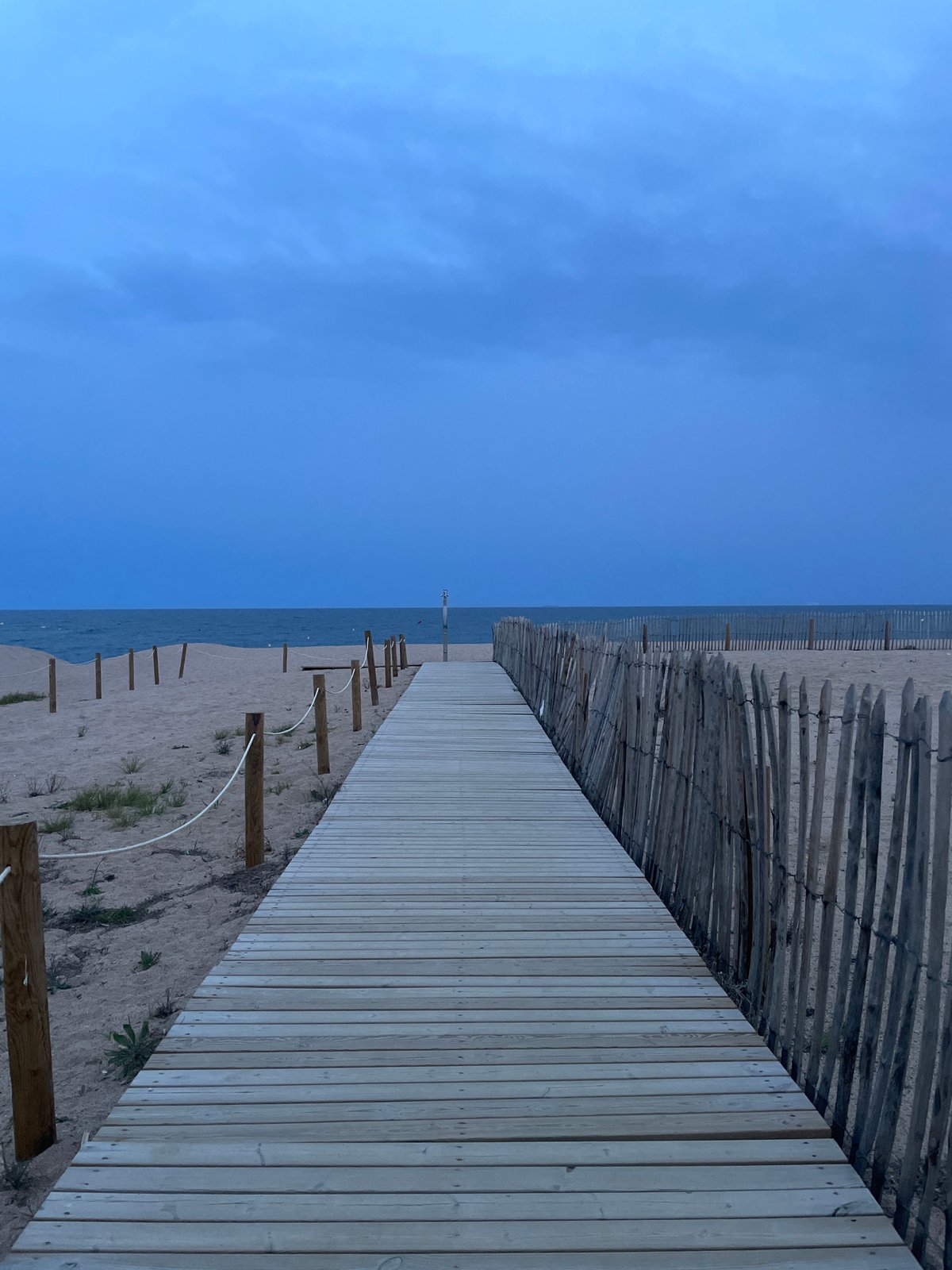 New wooden boardwalk observed extending to coastline in Calella